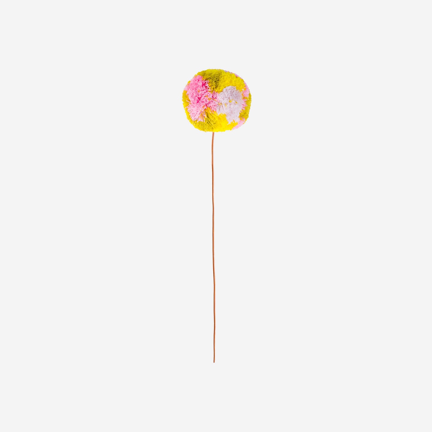 colored knitted pom pom on a wire with a white background