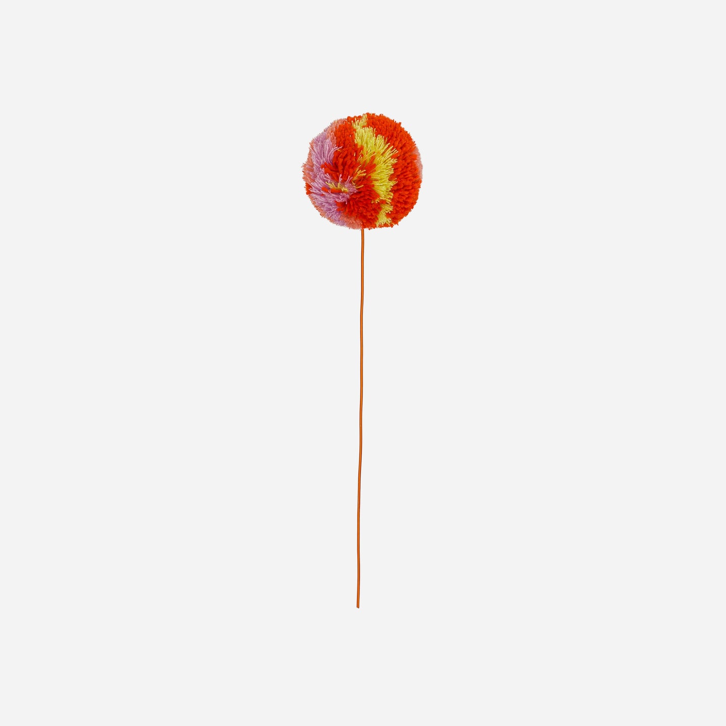 knitted poppy flower in pom pom with a white background