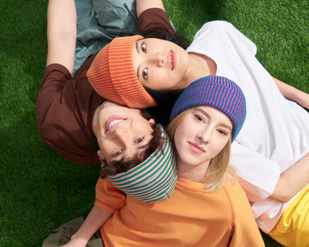 new colorful unisex ribbed beanies on 3 models in a park