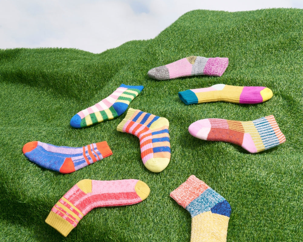 colorful house socks on a turf lawn