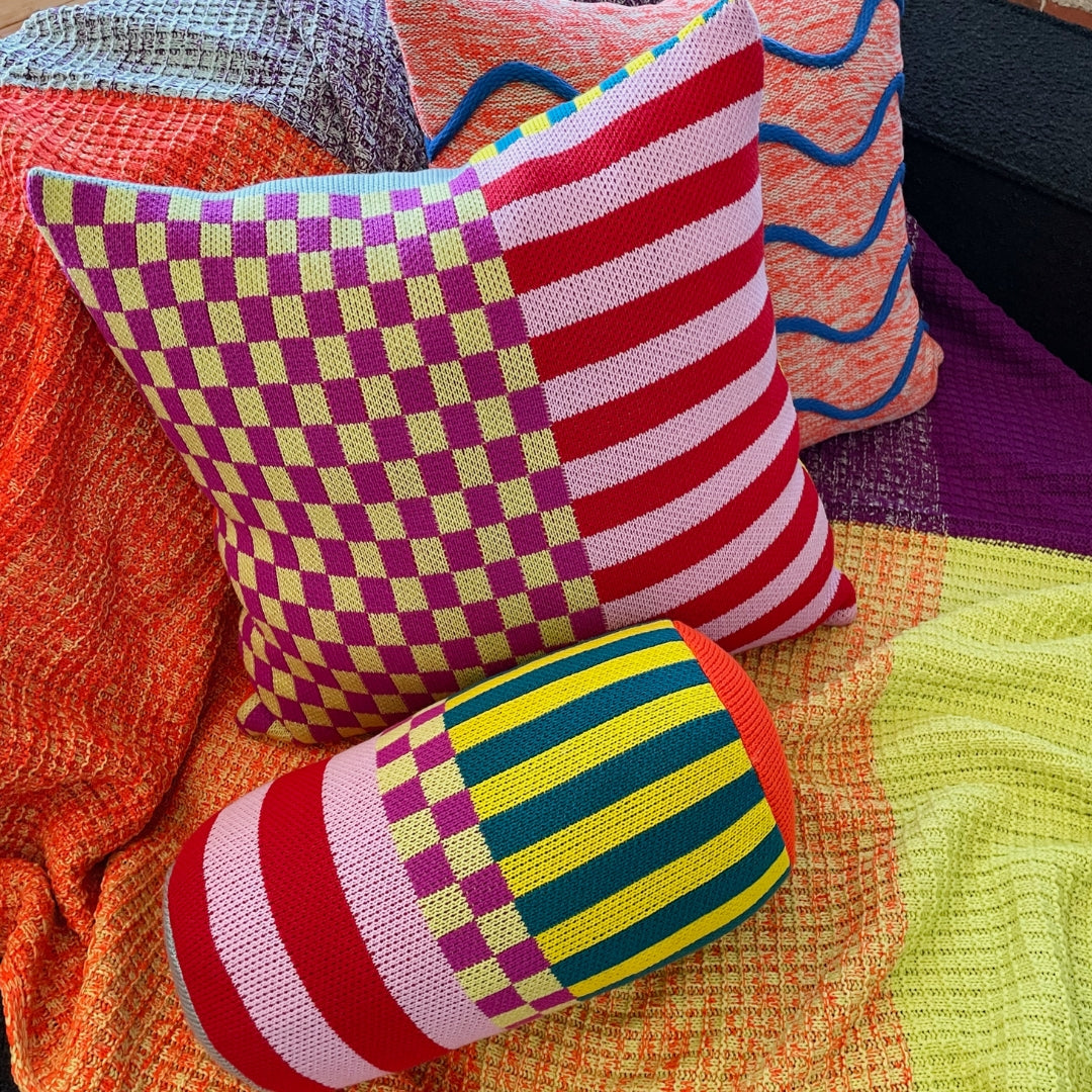 Verloop colorful patterned knit pillows on a couch