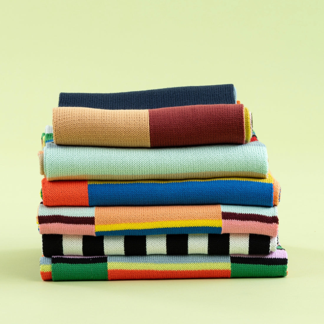 stack of colorful verloop knit scarves