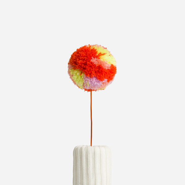 Poppy Lilac | knitted pom pon home decor that is orange purple and yellow
